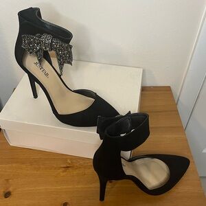 JustFab, black stiletto heels with a rhinestone bow. Faux suede pointed-toe